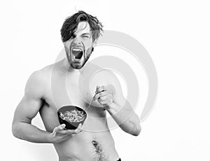 Caucasian sexy young macho holding black bowl with pasta