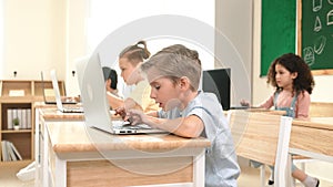 Caucasian child programing software system and learning about coding. Pedagogy.