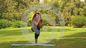 Caucasian sportswoman doing yoga at the open air