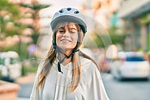 Caucasian sporty teenager girl smiling happy wearing bike helmet at the city