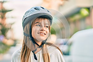 Caucasian sporty teenager girl smiling happy wearing bike helmet at the city