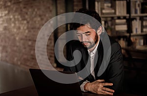 Caucasian successful professional diligent bearded and mustache male businessman in formal suit sitting at work desk typing laptop