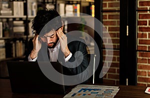 Caucasian successful professional diligent bearded and mustache male businessman in formal suit sitting at work desk typing laptop