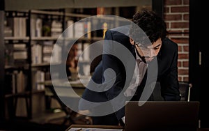 Caucasian successful professional diligent bearded and mustache male businessman in formal suit sitting at work desk typing laptop