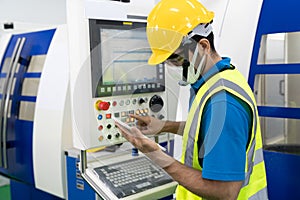 Caucasian technician use tablet to control cutting machines