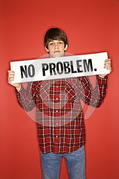 Caucasian teen boy holding no problem sign.