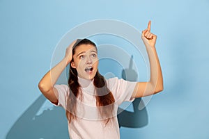 Caucasian teen girl portrait  on blue studio background