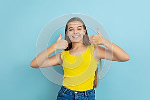 Caucasian teen girl portrait  on blue studio background