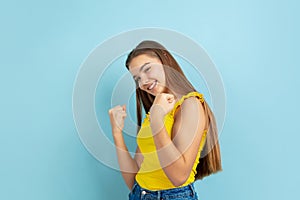 Caucasian teen girl portrait  on blue studio background