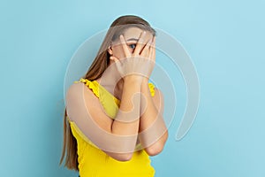 Caucasian teen girl portrait  on blue studio background