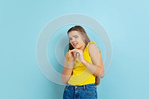 Caucasian teen girl portrait  on blue studio background