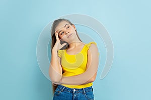 Caucasian teen girl portrait  on blue studio background