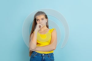 Caucasian teen girl portrait  on blue studio background