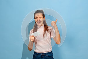 Caucasian teen girl portrait isolated on blue studio background