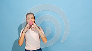 Caucasian teen girl portrait isolated on blue studio background