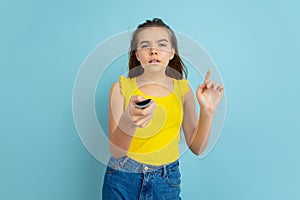 Caucasian teen girl portrait isolated on blue studio background