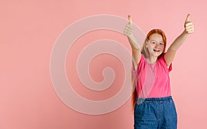 Caucasian teen girl`s portrait isolated on coral pink studio background.