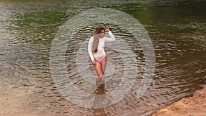 Caucasian Teen Girl Standing In River Wearing White Leotard