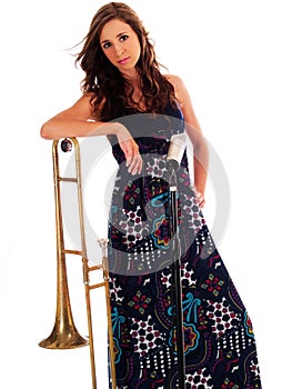 Caucasian Teen In Long Dress Leaning On Trombone
