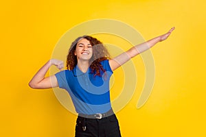 Caucasian teen`s girl portrait on yellow background