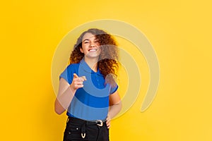 Caucasian teen`s girl portrait on yellow background