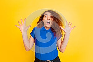 Caucasian teen`s girl portrait on yellow background