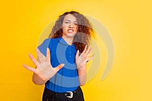 Caucasian teen`s girl portrait on yellow background