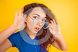 Caucasian teen`s girl portrait on yellow background