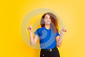 Caucasian teen`s girl portrait on yellow background