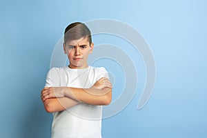 Caucasian teen`s portrait isolated on blue studio background