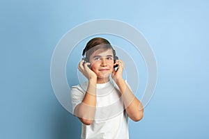 Caucasian teen`s portrait isolated on blue studio background