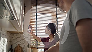 Caucasian teenager girl and her father having video call with mother while cooking.