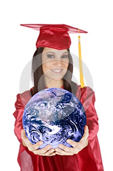 Caucasian teenager wearing a graduation gown holding the earth