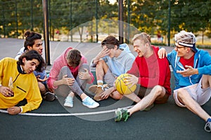 Caucasian teens, basketball players sitting and resting in timeout photo