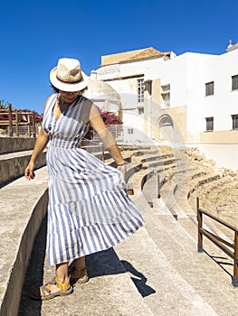 Caucasian tourist woman enjoying the Roman Theatre of Cadiz, Spain