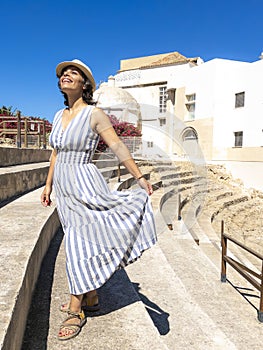 Caucasian tourist woman enjoying the Roman Theatre of Cadiz, Spain