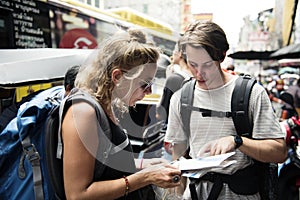 Caucasian tourists couple checking on the map