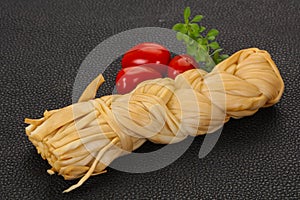 Caucasian traditional pigtail cheese served tomatoes