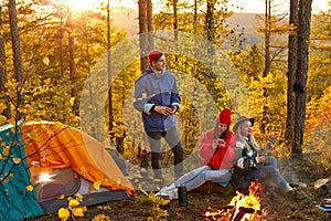 Caucasian travellers relax in forest. hiking and camping together