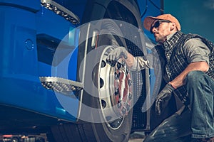 Truck Driver Checking Tires photo