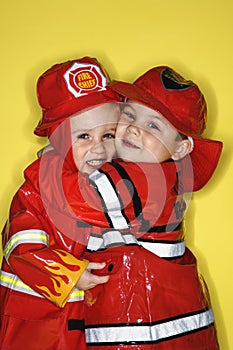 Caucasian twin boys dressed as firemen.