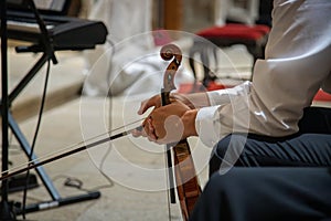 Caucasian violinist man wearing classical clothes and waiting for moment to start musical performance.