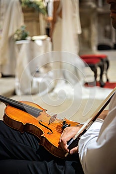 Caucasian violinist man wearing classical clothes and waiting for moment to start musical performance.