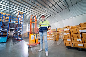 Caucasian warehouse worker man action of pull cargo small truck that carry product boxes in area of workplace