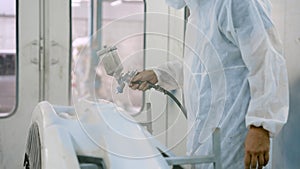 Caucasian wearing PPE to prevent contamination For safety of working in spray room windless Close-up of man's hand