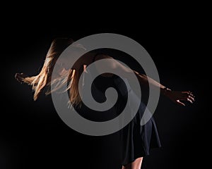 Caucasian white female model portrait. The wind blowing the long blonde hair off on beautiful girl.