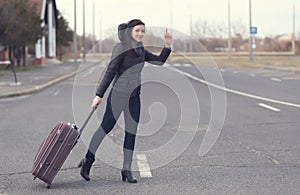 Caucasian white woman calling taxi with arm raised