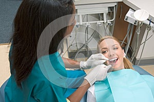 Caucasian woman and African-American dentist