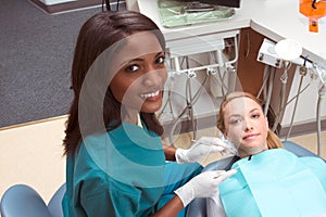 Caucasian woman and African-American dentist