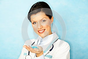 Caucasian woman as a doctor holding meds photo